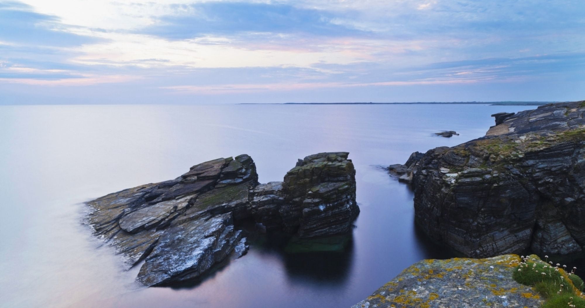 Rock and tranquil water along the coastline at dawn Orkney Scotland Canvas Art - Kav Dadfar Design Pics (21 x 11)