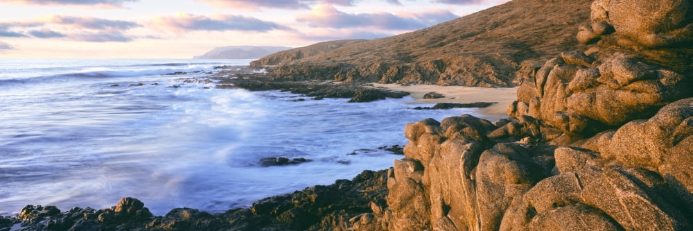 Rock formations on coast at sunset Cerritos Beach between Cabo San Lucas and Todos Santos Baja California Sur Mexico Canvas Art - Panoramic Images (27 x 9)