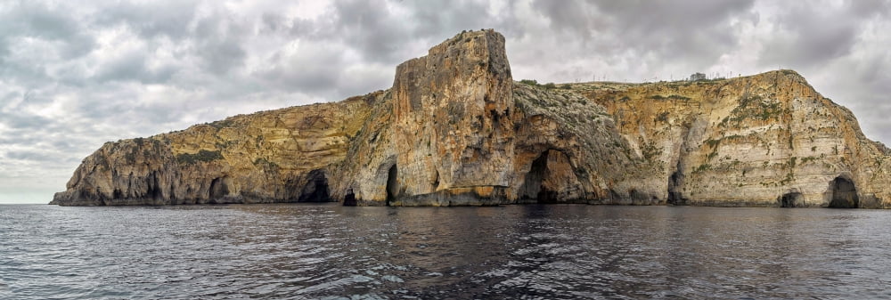 Rock formations in Mediterranean sea Blue Grotto Malta Canvas Art - Panoramic Images (12 x 36)