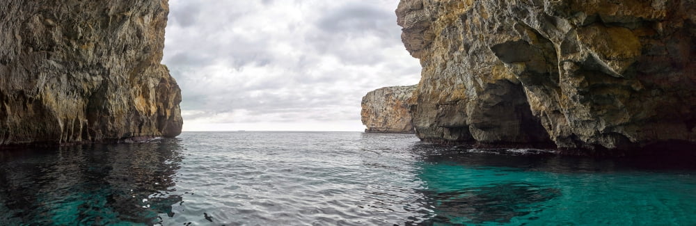 Rock formations in Mediterranean sea Blue Grotto Malta Canvas Art - Panoramic Images (6 x 18)