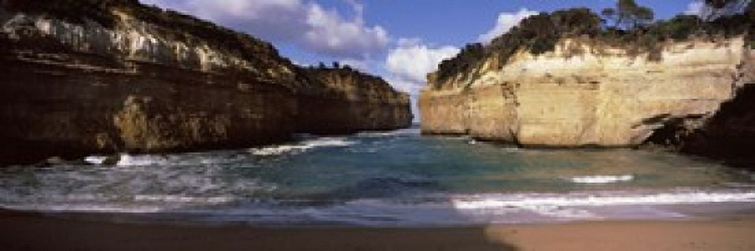 Rock formations in the ocean Loch Ard Gorge Port Campbell National Park Great Ocean Road Victoria Australia Canvas Art - Panoramic Images (18 x 6)
