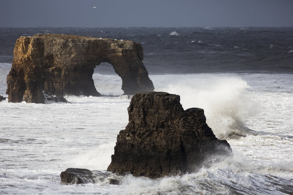 Rock formations and a natural arch in the ocean with splashing wavesSouth Shields Tyne and Wear England Canvas Art - John Short Design Pics (38 x 24)