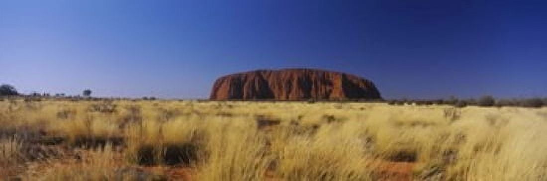 Rock formations on a landscape Ayers Rock Uluru-Kata Tjuta National Park Northern Territory Australia Canvas Art - Panoramic Images (18 x 6)