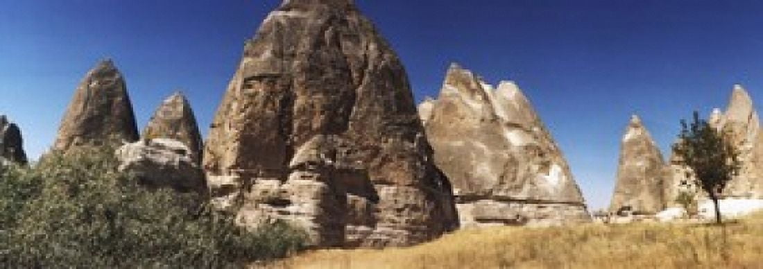 Rock formations on a landscape Cappadocia Central Anatolia Region Turkey Canvas Art - Panoramic Images (18 x 7)