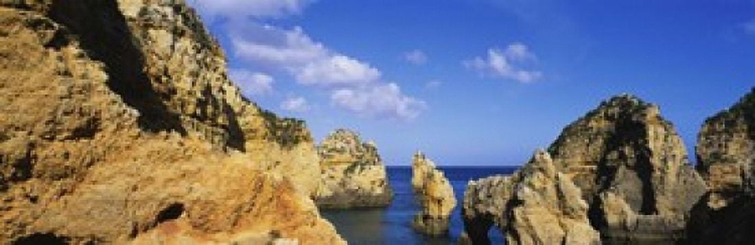 Rock formations on the beach Lagos Algarve Portugal Canvas Art - Panoramic Images (18 x 6)