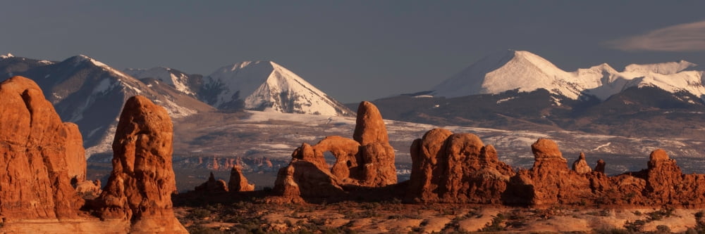 Rock formations with snow covered mountain range in the background Turret Arch La Sal Mountains Arches National Park Utah USA Canvas Art - Panoramic Images (6 x 18)