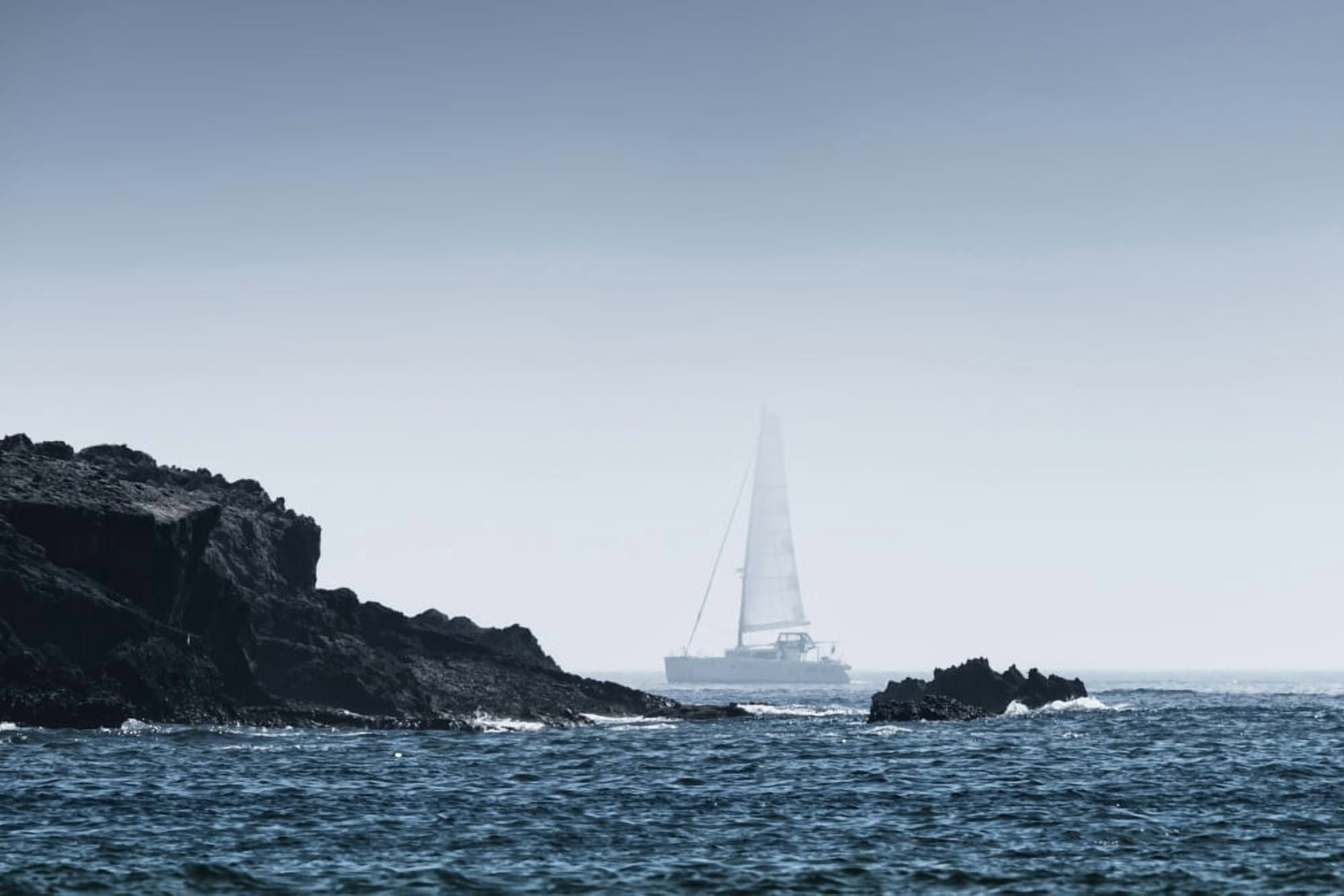 Rock on the rugged coastline with a sailboat in the fog Tarifa Cadiz Andalusia Spain Canvas Art - Ben Welsh Design Pics (38 x 24)