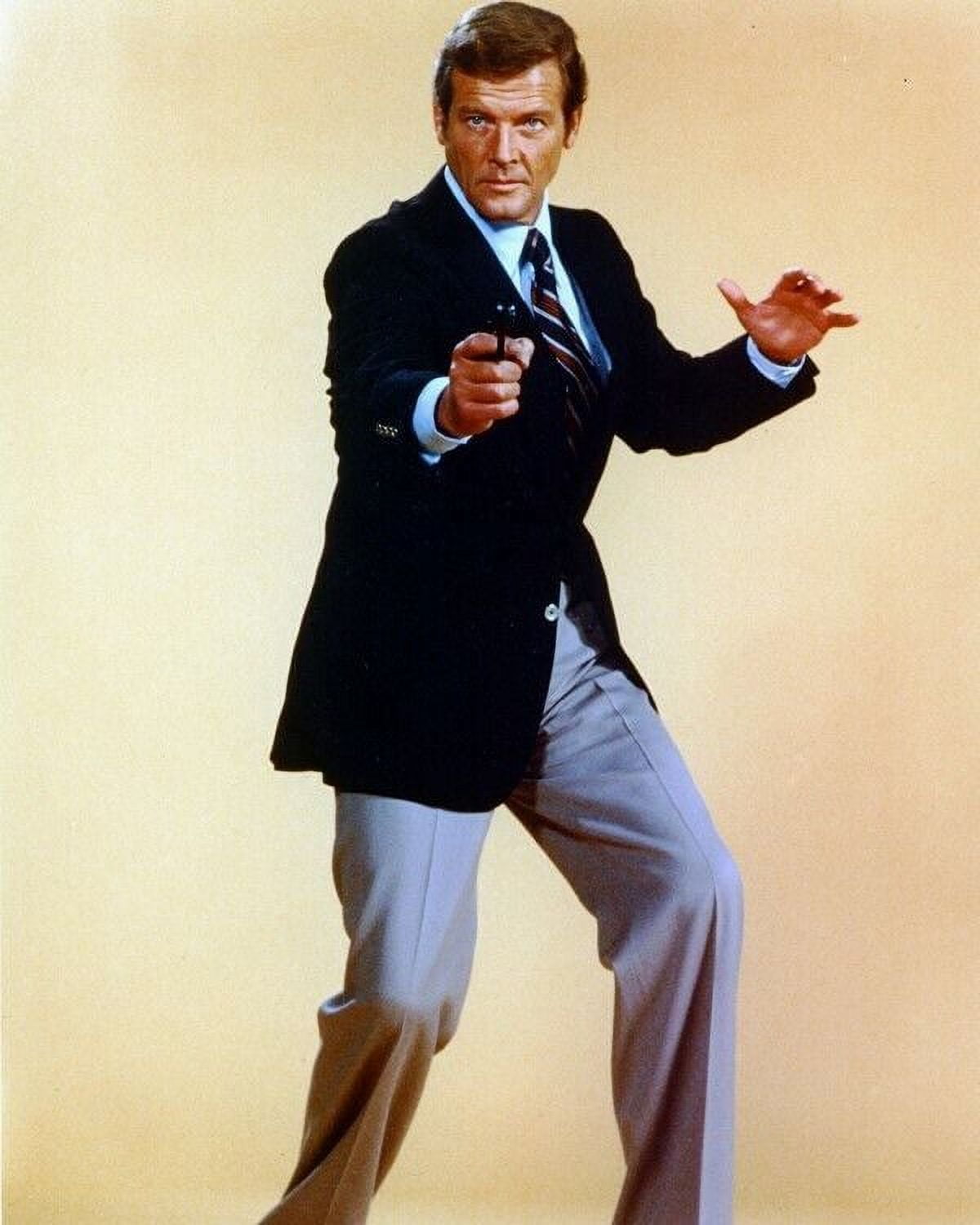 Roger Moore Moore in classic 007 James Bond pose pointing un full length Poster