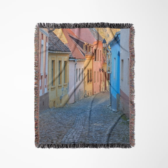 Romania, Sighisoara, Cobblestone Street Of Colorful Houses In Village., Woven Blanket
