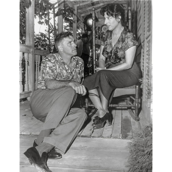 Rose Tattoo Woman Seated on Chair with Man Seated on Floor Photo Print (24 x 30)