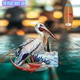 thumbnail image 1 of Rotating acrylic display showcasing a pelican skimming water with sandy shores and blue sea lavender in vibrant, detailed colors against a pure white background, 1 of 6