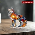 thumbnail image 1 of Rotating acrylic ornament features colorful glass fragments forming a decorative wolf glowing brilliantly in sunlight against a pure white background, 1 of 8