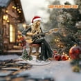 thumbnail image 1 of Rotating acrylic ornament featuring Stevie Nicks in a Santa hat playing guitar on a Christmas chair with festive decorations and a white background, 1 of 7