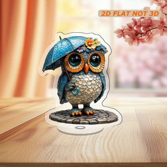 Rotating acrylic ornament featuring a colorful glass owl with a rain hat and umbrella, wearing a cyan raincoat on a cobblestone road