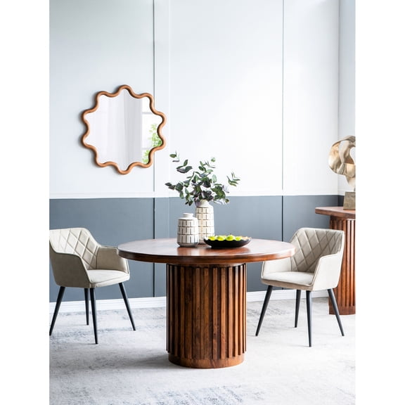 Round table with carved base / For hosting family events / Offers comfort seating