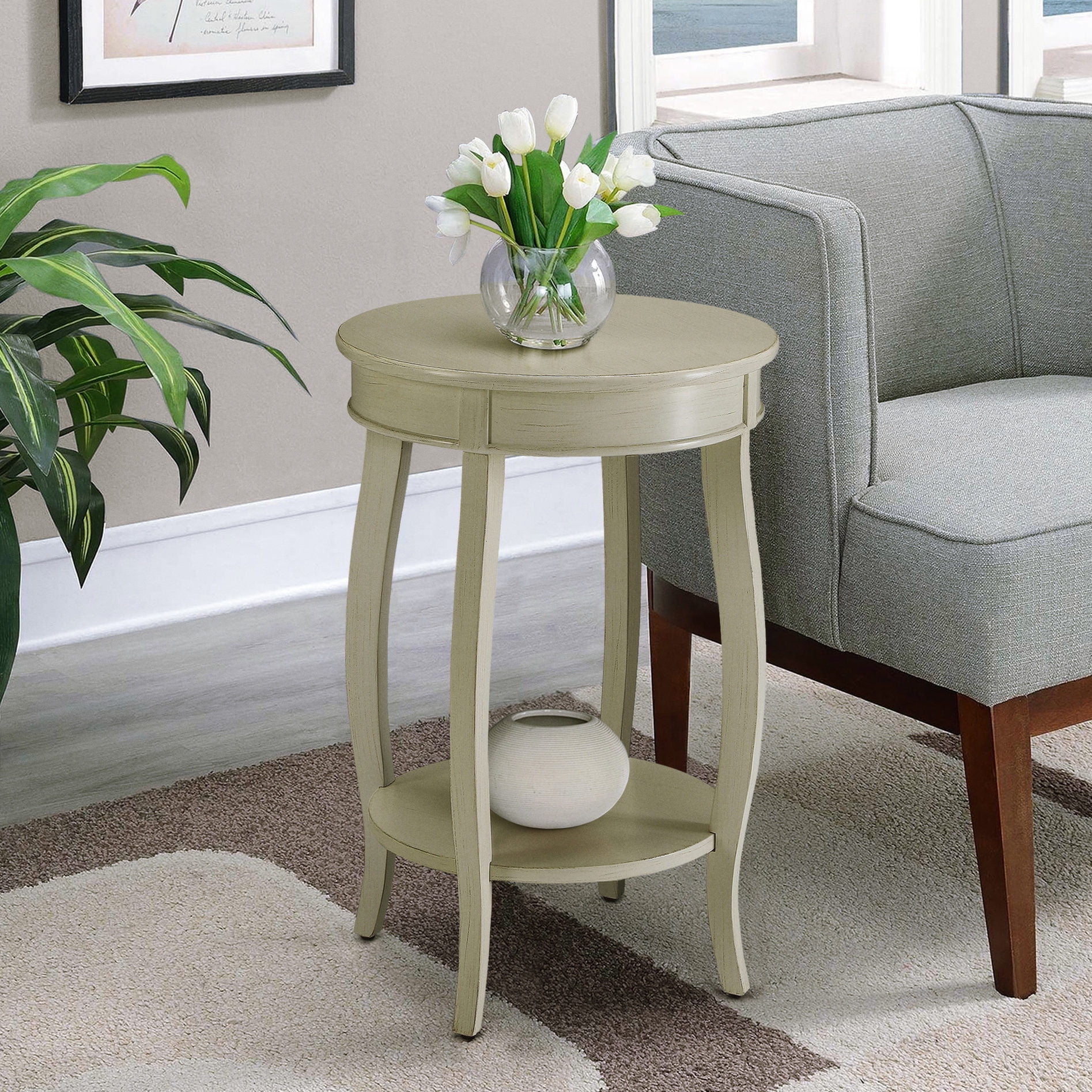 Round wooden side table in antique white for living area has bottom shelf for storage and ensures long - lasting durability