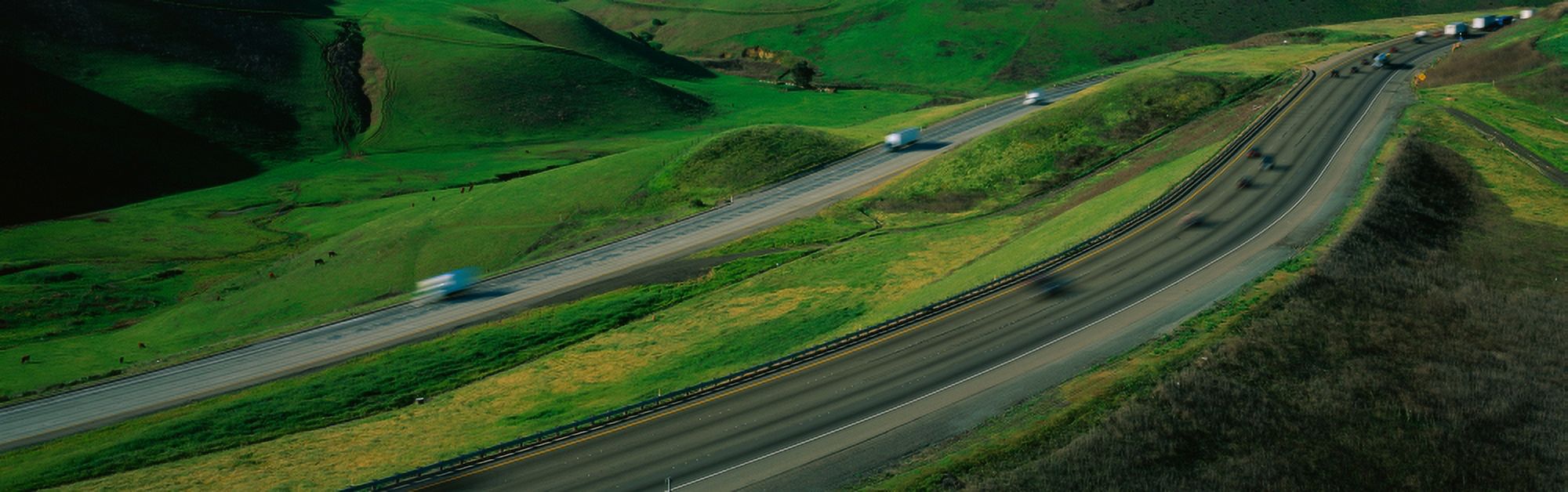 This is Route 580 at the Altamont Pass There is green grass on each side of the highway with two separate roads for cars to travel in each direction Canvas Art - Panoramic Images (36 x 12)