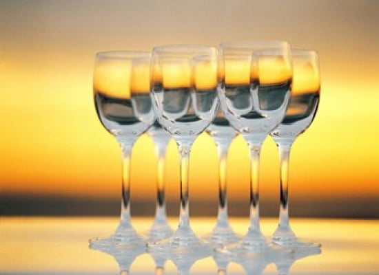 Row Of Wineglasses Against Golden Yellow shiny Background Canvas Art - Panoramic Images (36 x 27)