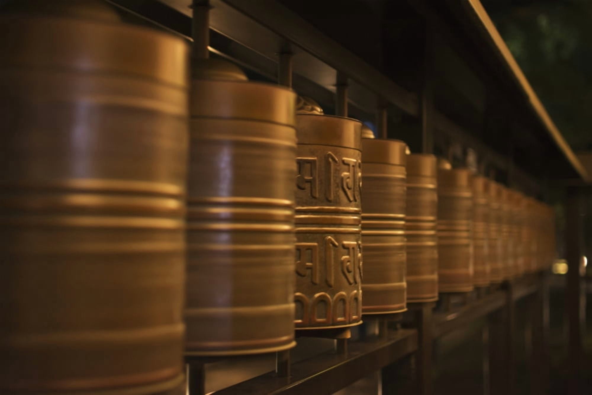 Row of spinning prayer wheels at night one is stopped Kyoto Japan Canvas Art - Philippe Widling Design Pics (19 x 12)