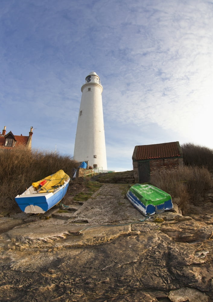 Rowboats Abandoned On The Shore In Front Of The Lighthouse On St Marys Island Northumberland England Canvas Art - John Short Design Pics (26 x 36)