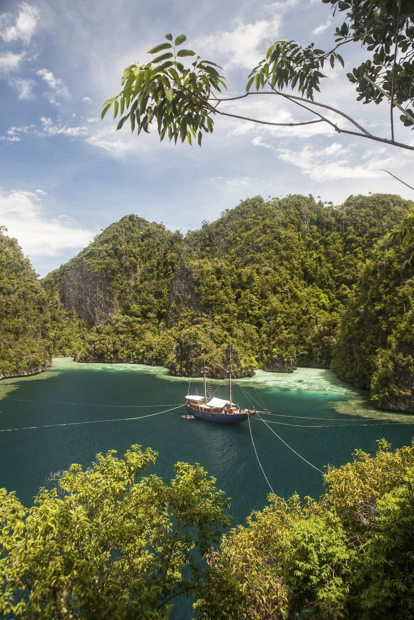 Rugged limestone islands frame an Indonesian pinisi schooner Canvas Art - Ethan DanielsStocktrek Images (12 x 17)