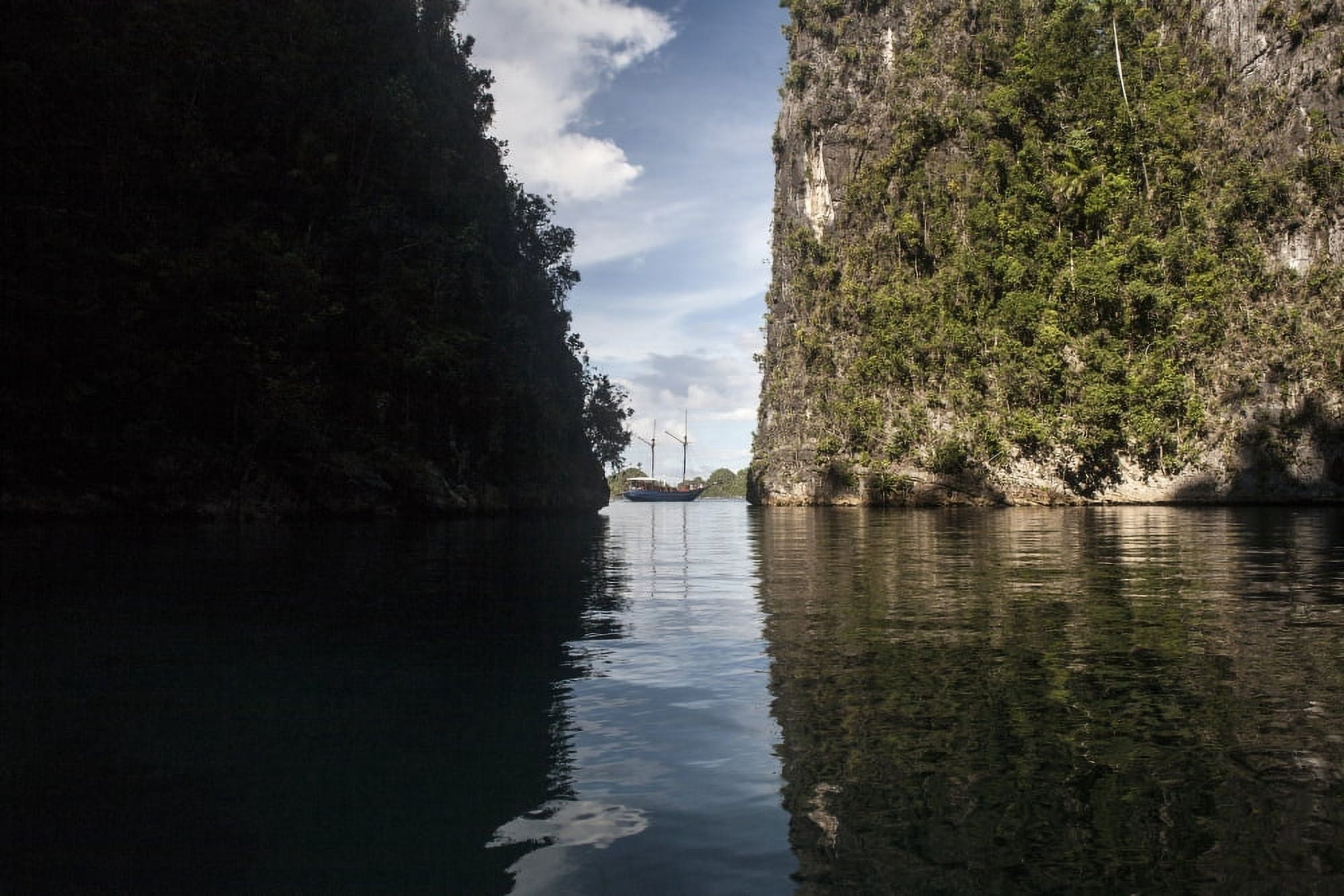 Rugged limestone islands frame an Indonesian pinisi schooner Canvas Art - Ethan DanielsStocktrek Images (17 x 12)