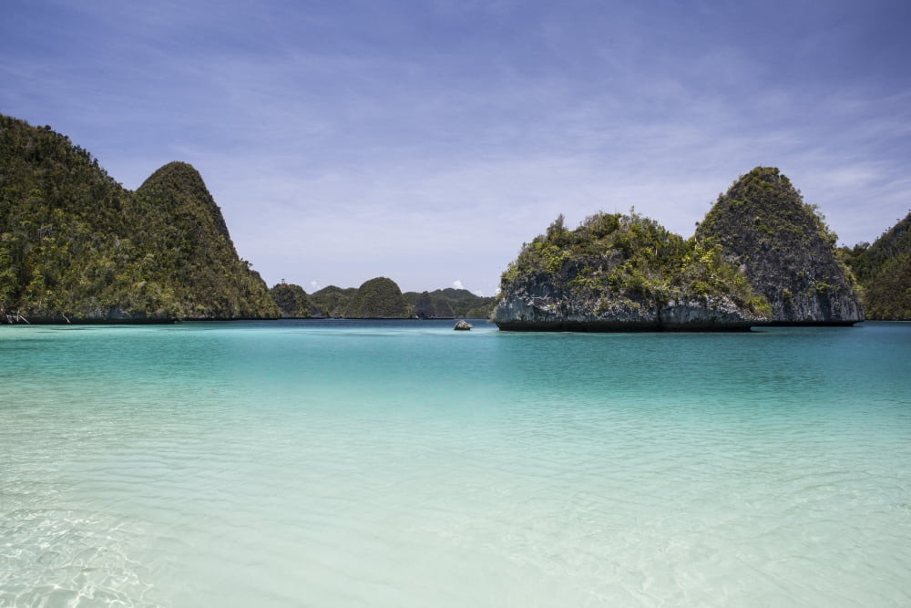 Rugged limestone islands surround a gorgeous lagoon in Raja Ampat Canvas Art - Ethan DanielsStocktrek Images (17 x 12)