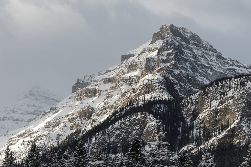 Rugged mountain peak with snow under a cloudy sky Lake Louise Alberta Canada Canvas Art - Keith Levit Design Pics (19 x 12)