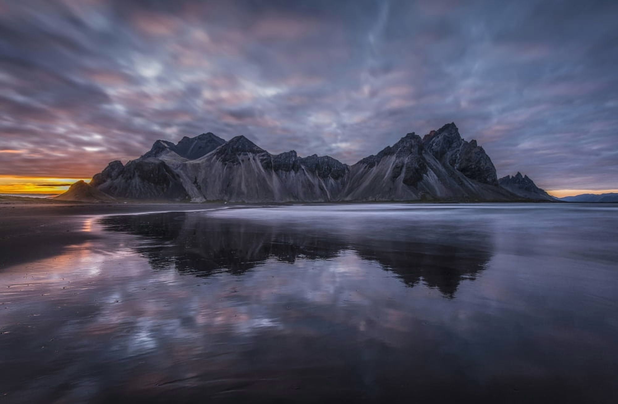 Rugged mountain peaks and a colourful sunset reflected in tranquil water Iceland Canvas Art - Jonathan Tucker Design Pics (19 x 12)