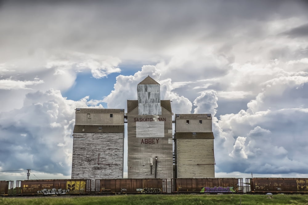 Rural grain elevator with cumulonimbus clouds building up around it Saskatchewan Canada Canvas Art - Robert Postma Design Pics (38 x 24)