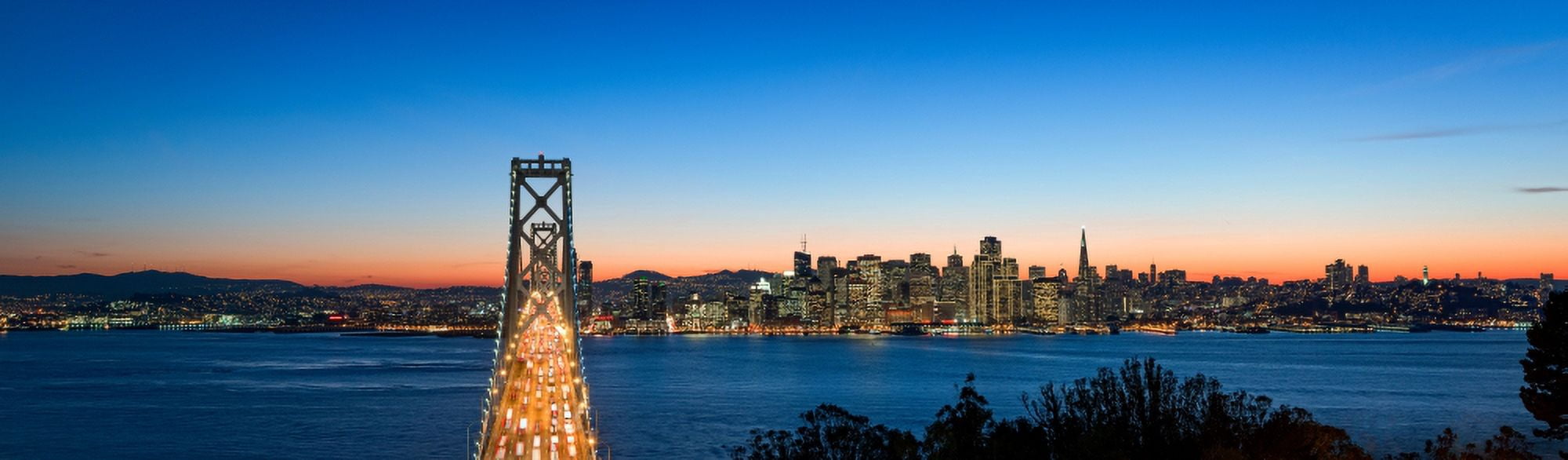 Rush hour traffic on the Bay Bridge with San Francisco skyline at dusk San Francisco Bay California USA Canvas Art - Panoramic Images (36 x 12)