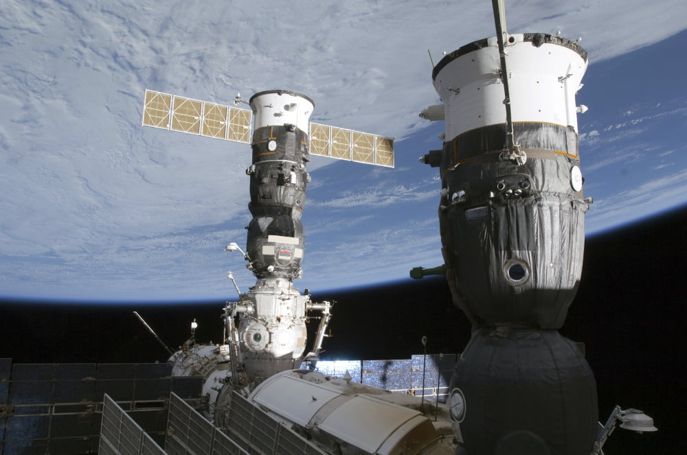 Russian Soyuz and Progress spacecrafts docked to the International Space Station Canvas Art - Stocktrek Images (34 x 23)
