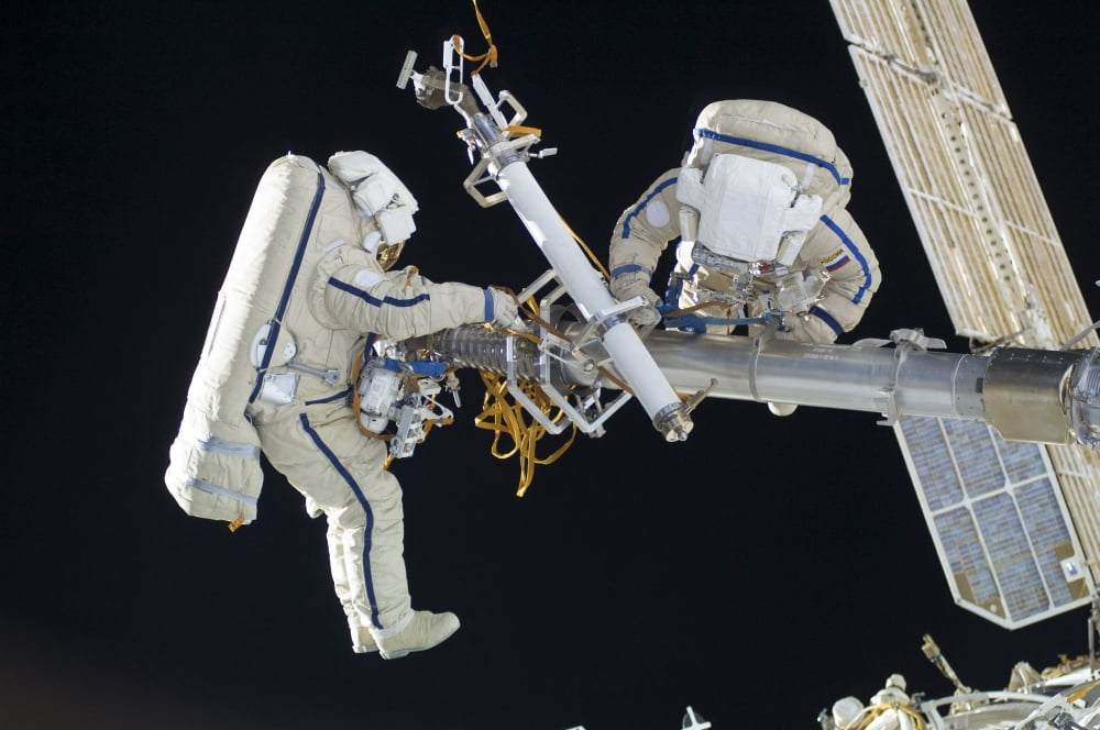 Russian cosmonauts working on the International Space Station Canvas Art - Stocktrek Images (35 x 23)
