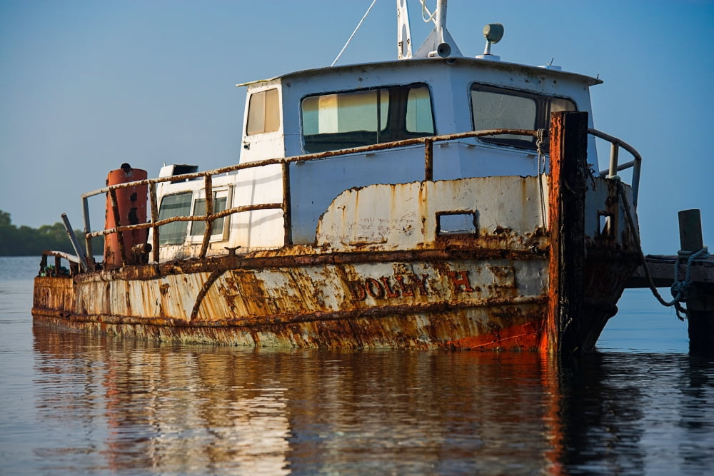 Rusty boat moored in a lake at sunrise Placencia Stann Creek Belize Canvas Art - Panoramic Images (18 x 24)