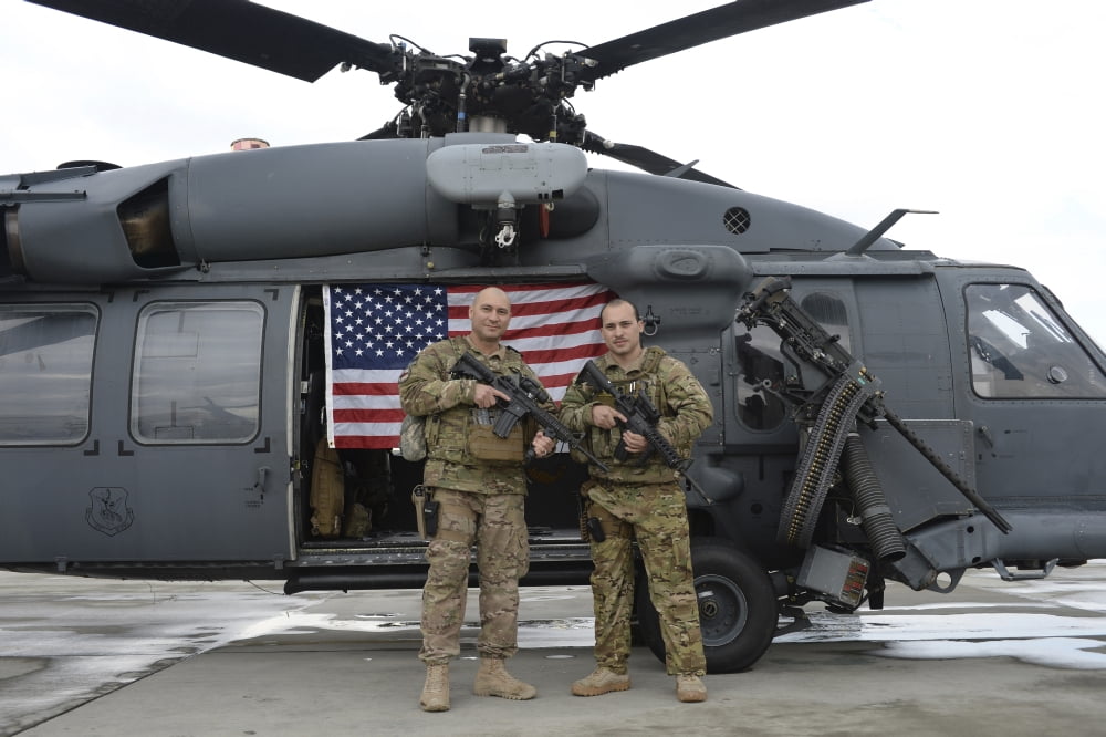 S Air Force flight engineer and his father pose in front of an HH-60 Pave Hawk Canvas Art - Stocktrek Images (34 x 23)