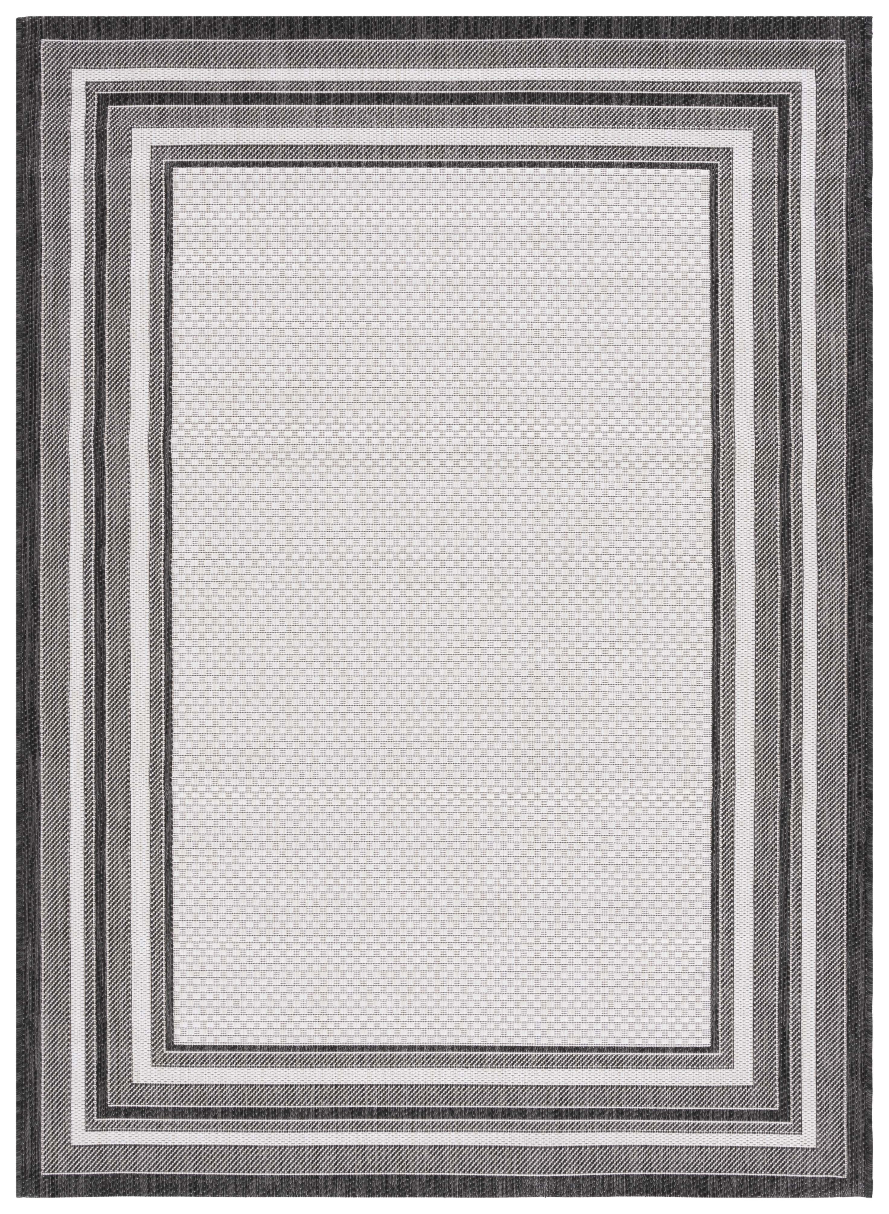 Ivory and Black Reversible Synthetic Indoor/Outdoor Rug