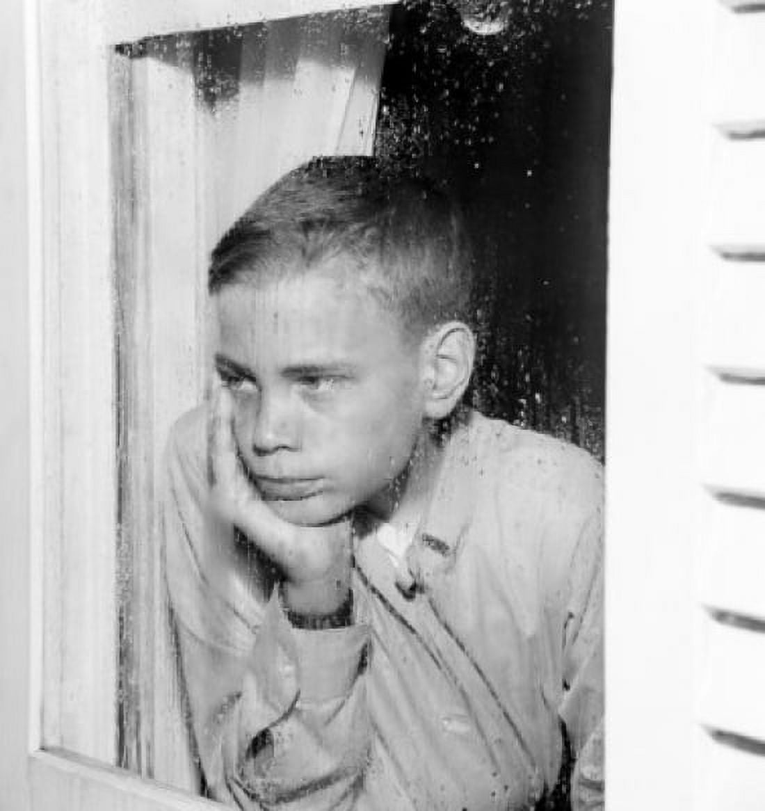 Sad boy looking through window Canvas Art - (18 x 24)