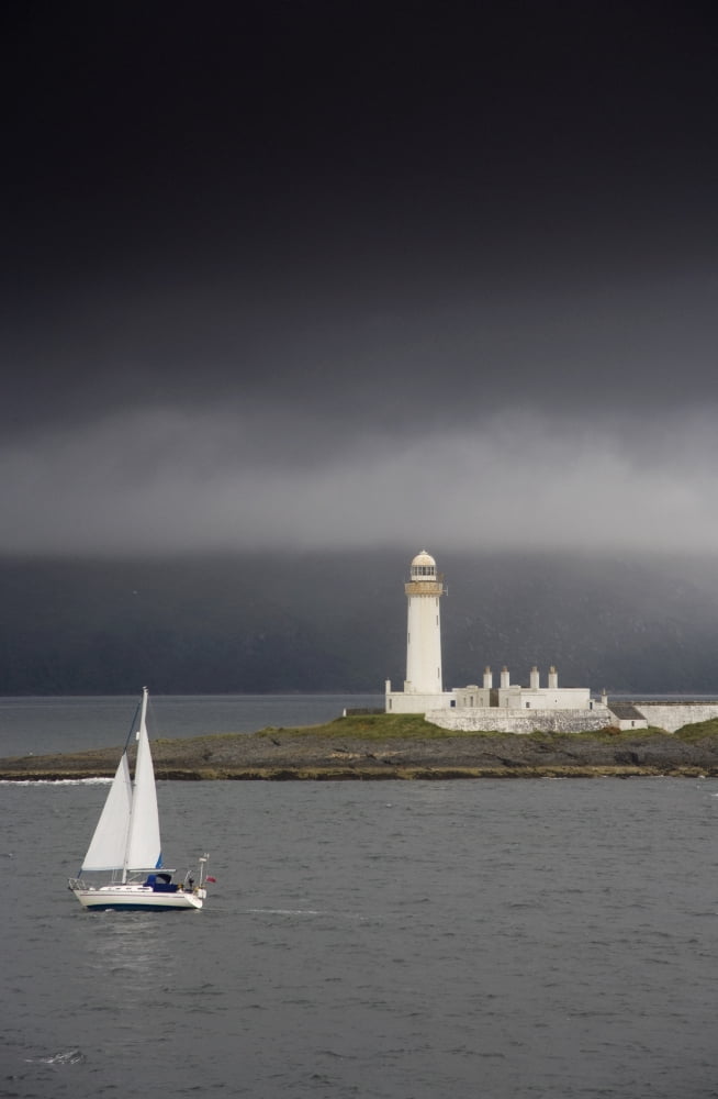 Sailboat Near A Shore With A Lighthouse Eilean Musdile In The Firth Of LornScotland Canvas Art - John Short Design Pics (12 x 19)