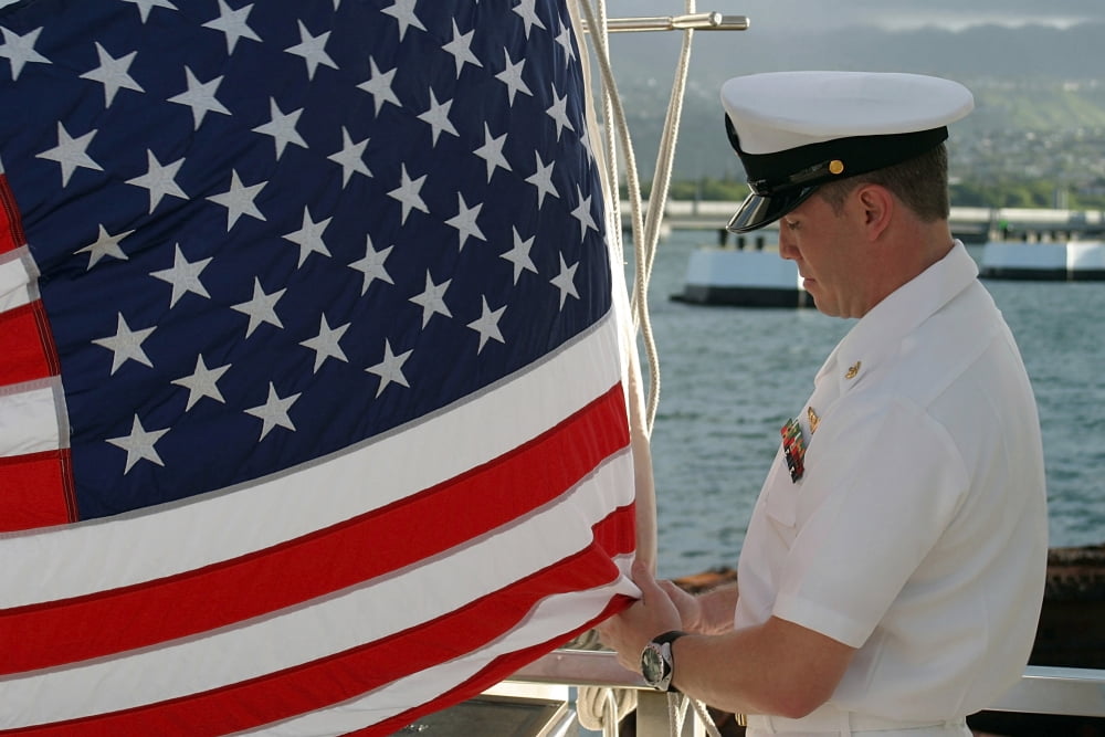 Sailor raises an American flag above the USS Arizona Memorial in Pearl Harbor Hawaii Canvas Art - Stocktrek Images (34 x 23)
