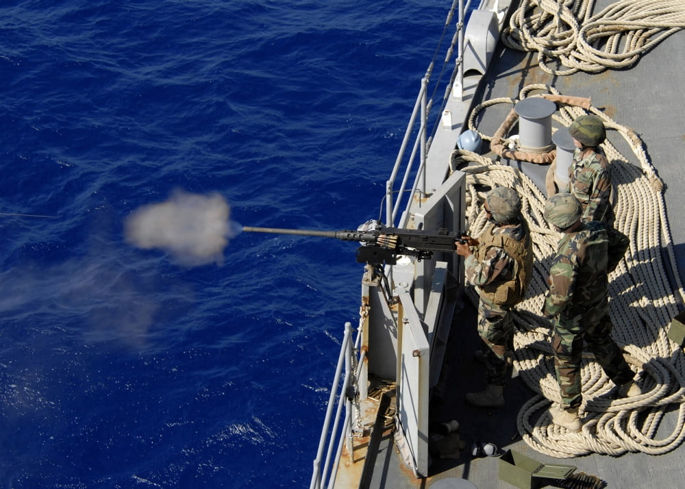 Sailors aboard USS Fort McHenry fire a 50-caliber gun mount system Canvas Art - Stocktrek Images (34 x 24)