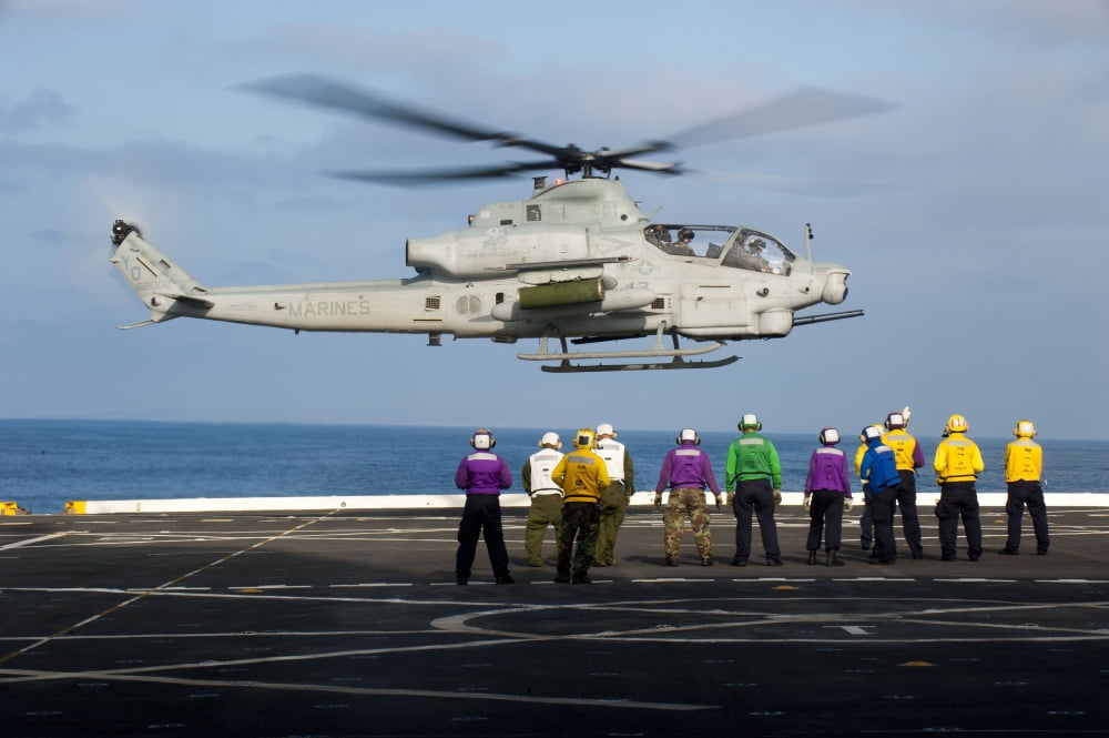 Sailors and Marines watch an AH-1Z Viper attack helicopter lift off the flight deck of USS New Orleands Canvas Art - Stocktrek Images (35 x 23)