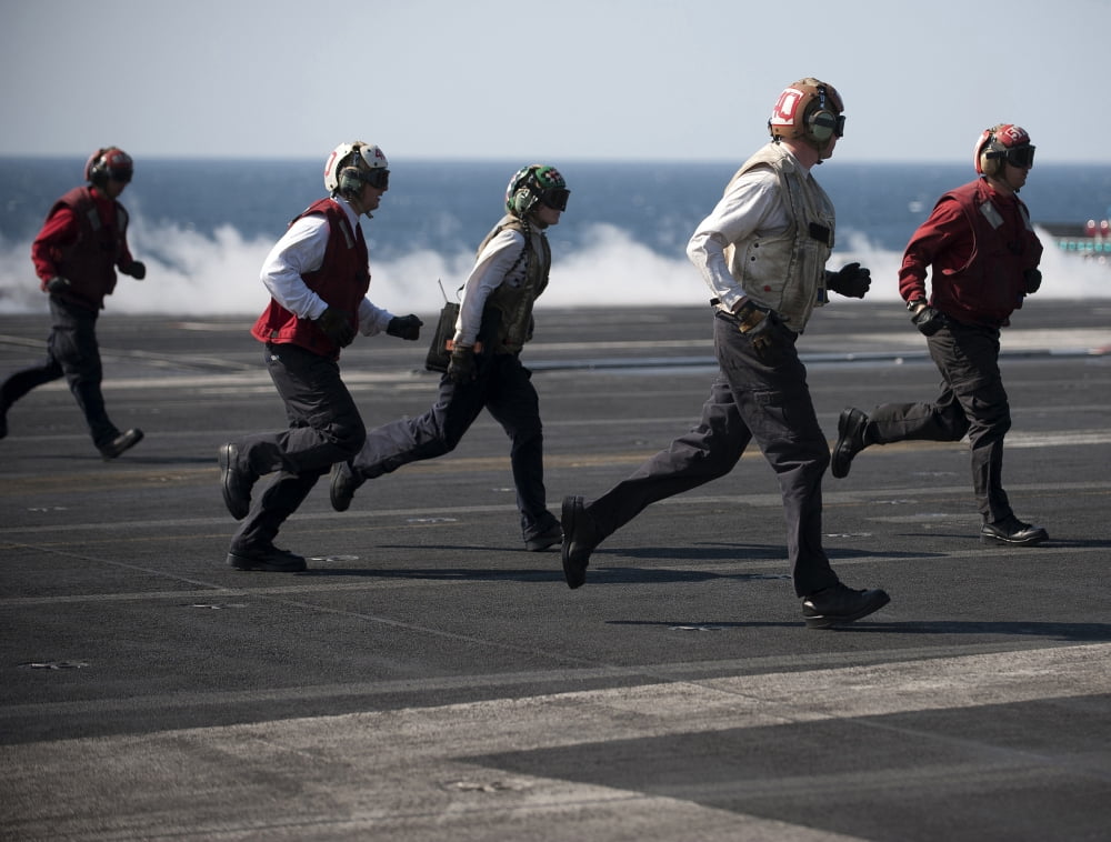 Sailors clear the landing area on the flight deck of USS Carl Vinson Canvas Art - Stocktrek Images (33 x 25)