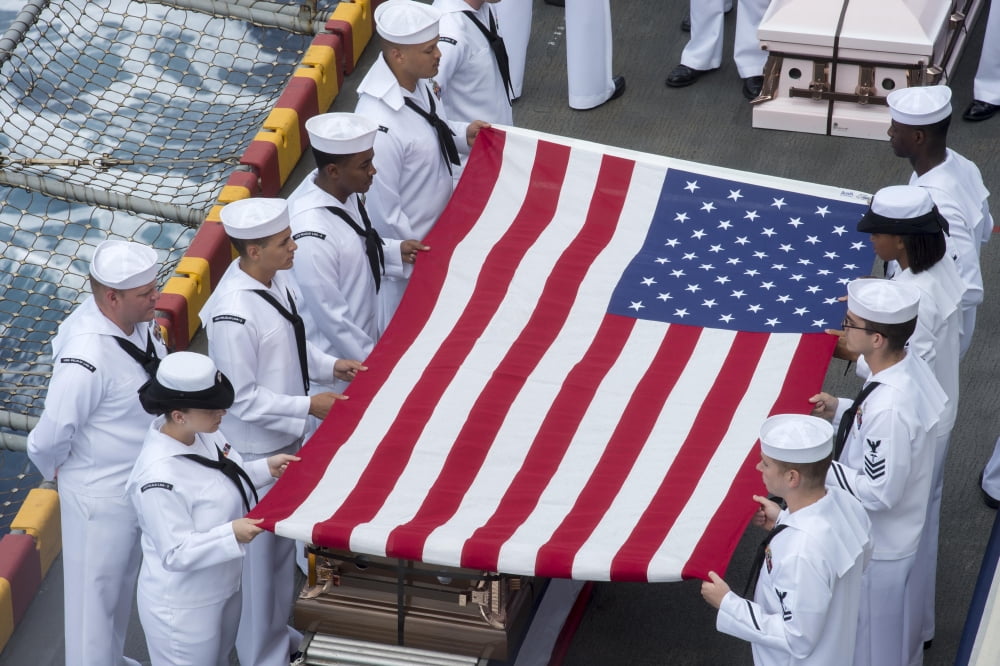 Sailors commit a casket into the sea during a burial at sea ceremony Canvas Art - Stocktrek Images (34 x 23)