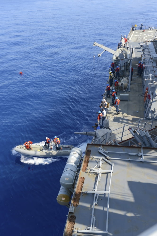 Sailors execute rescue operations in a rigid-hull inflatable boat Canvas Art - Stocktrek Images (23 x 34)