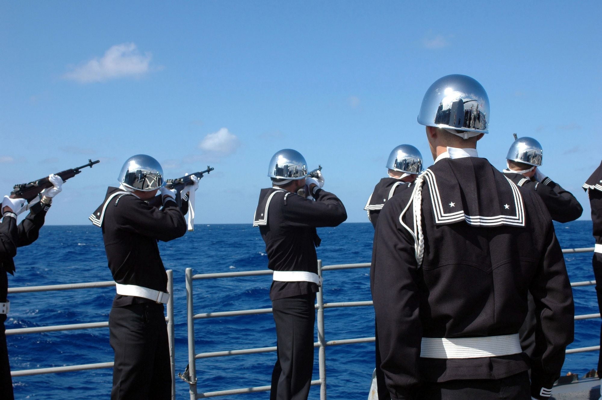 Sailors fire a gun salute during a burial-at-sea Canvas Art - Stocktrek Images (34 x 23)