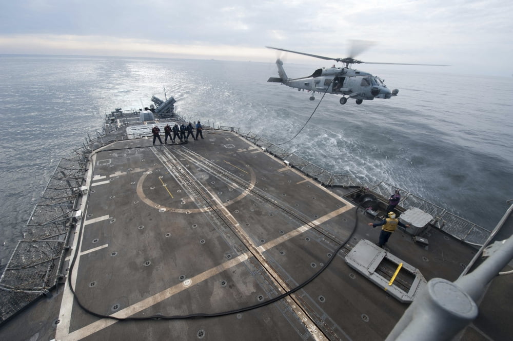 Sailors hold a fuel line during a helicopter-in-flight refueling exercise Canvas Art - Stocktrek Images (35 x 23)