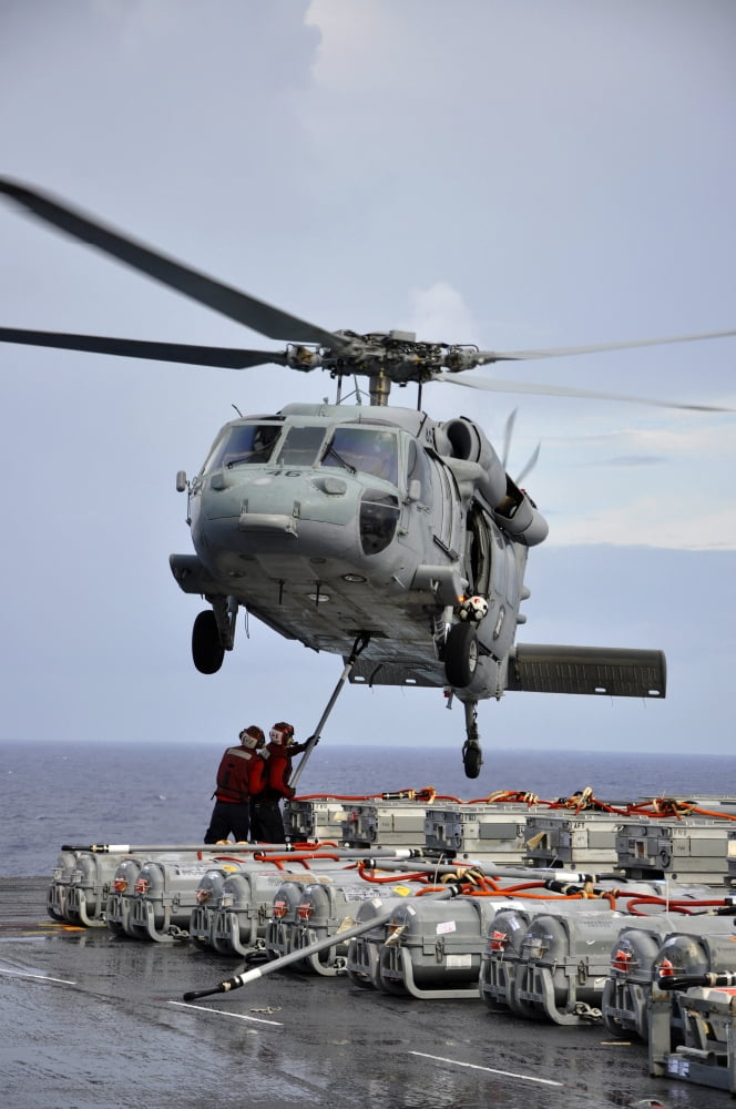 Sailors hook an ammunition pallet to an MH-60S Sea Hawk helicopter Canvas Art - Stocktrek Images (23 x 34)