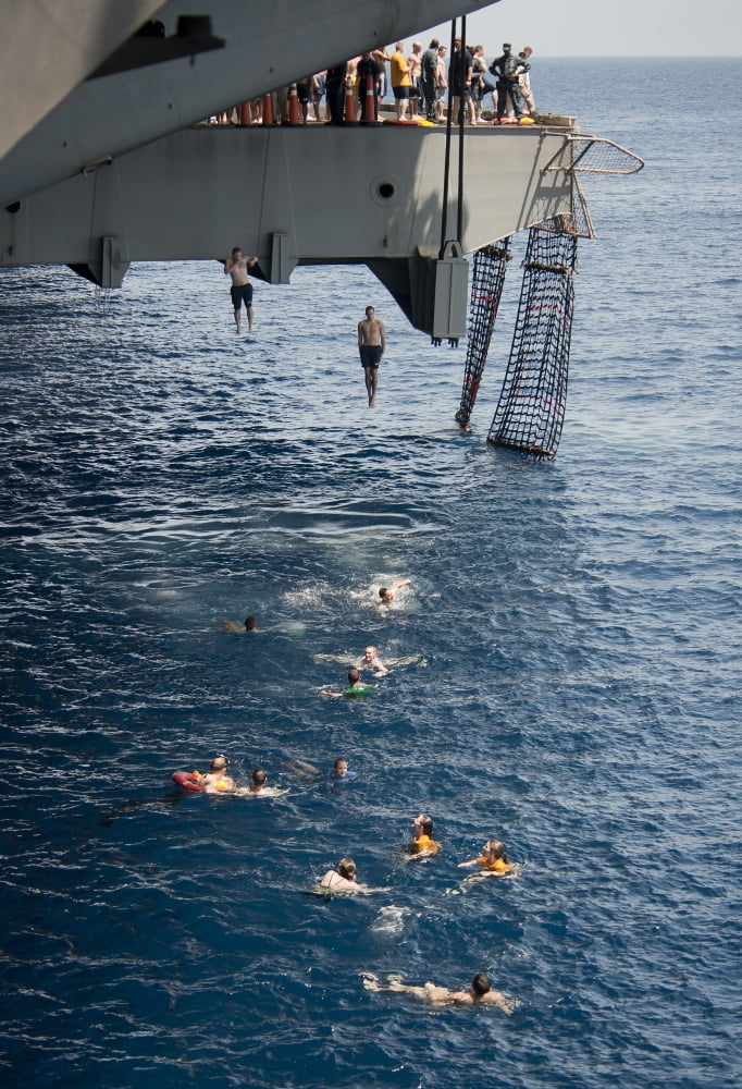 Sailors jump to the sea during a swim call aboard USS Carl Vinson Canvas Art - Stocktrek Images (24 x 34)