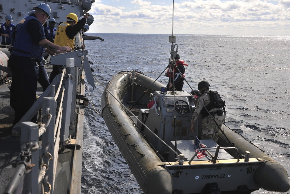Sailors lift a rigid-hull inflatable boat aboard USS Porter Canvas Art - Stocktrek Images (35 x 23)