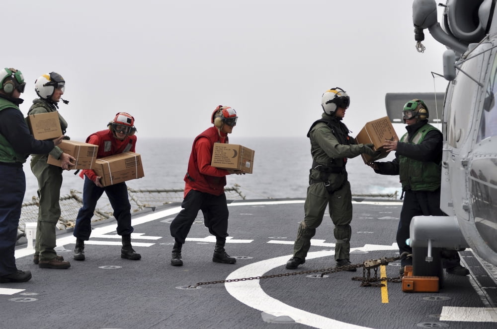 Sailors load boxes of food onto an SH-60F Sea Hawk helicopter Canvas Art - Stocktrek Images (34 x 23)